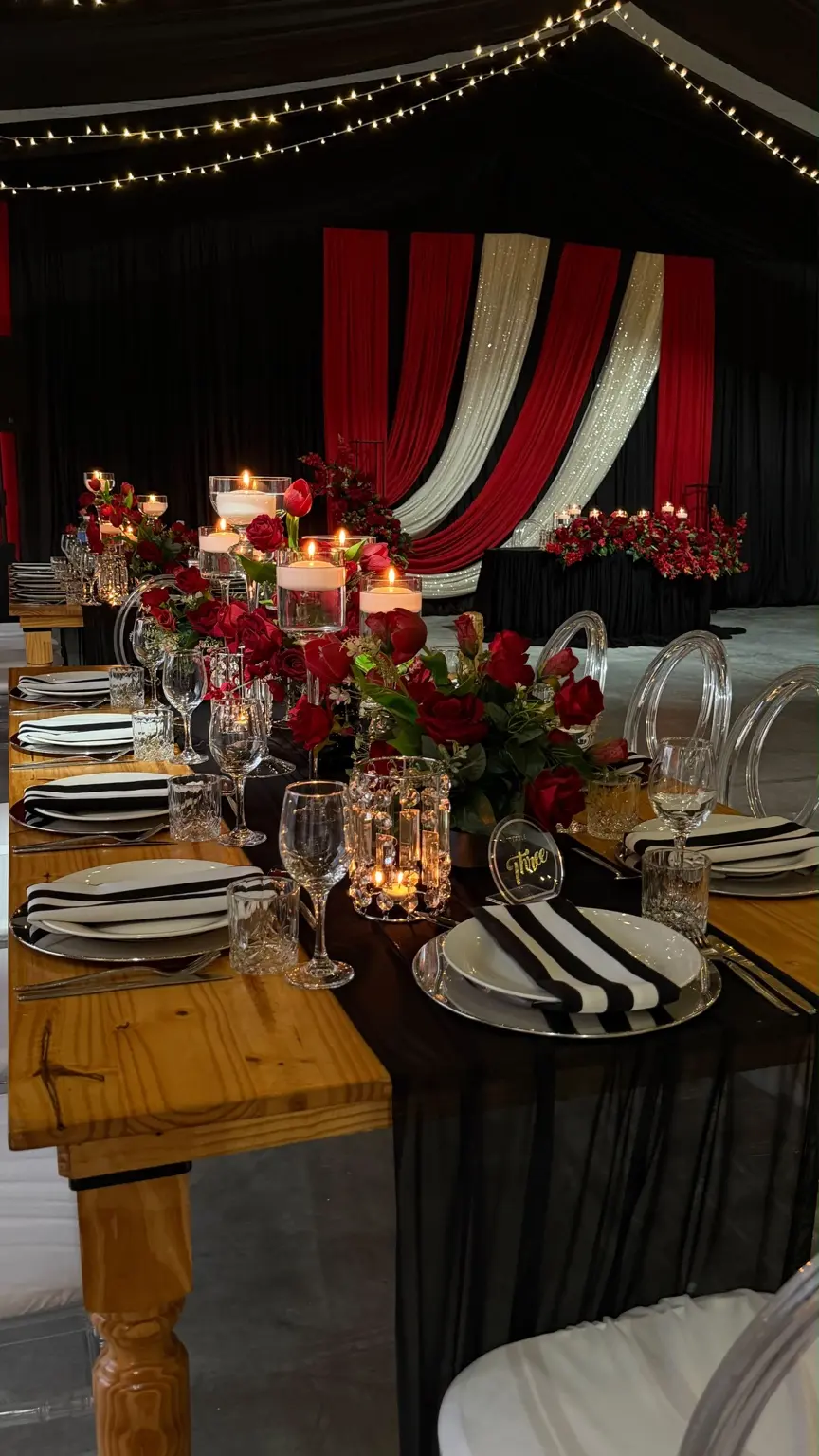 Candlelit red and black wedding tablescape created by Khan Events