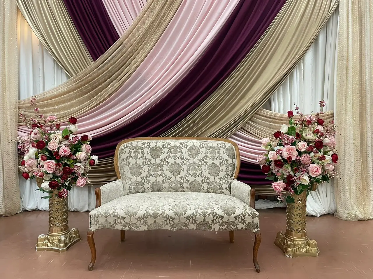 Plum, blush and gold wedding stage and draping by Khan Events